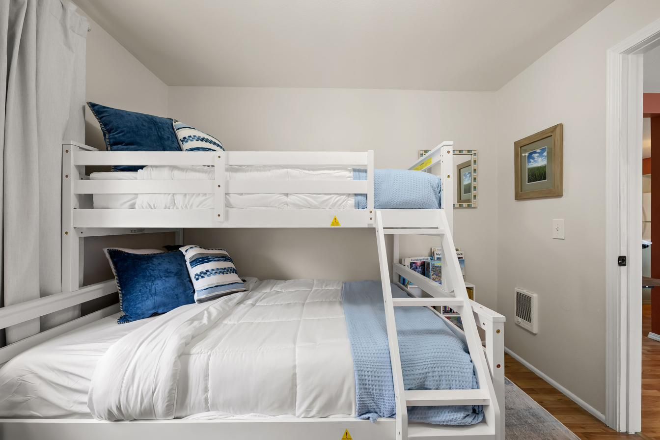 Bunk beds made up with blue and white bedding