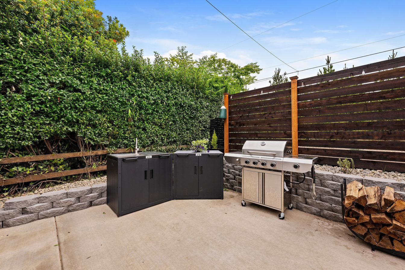 Outdoor kitchen with grill, sink and storage