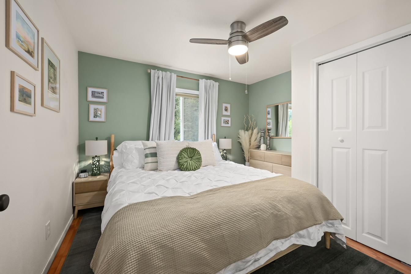 The master bedroom with a sage green accent wall
